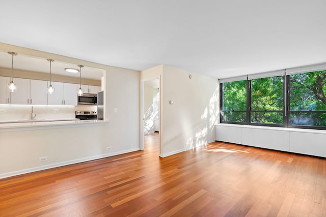 unfurnished living room with light wood-type flooring