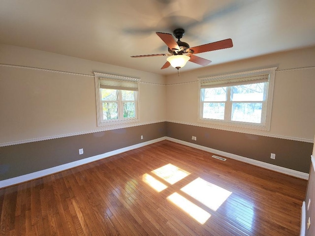 unfurnished room with hardwood / wood-style flooring and ceiling fan