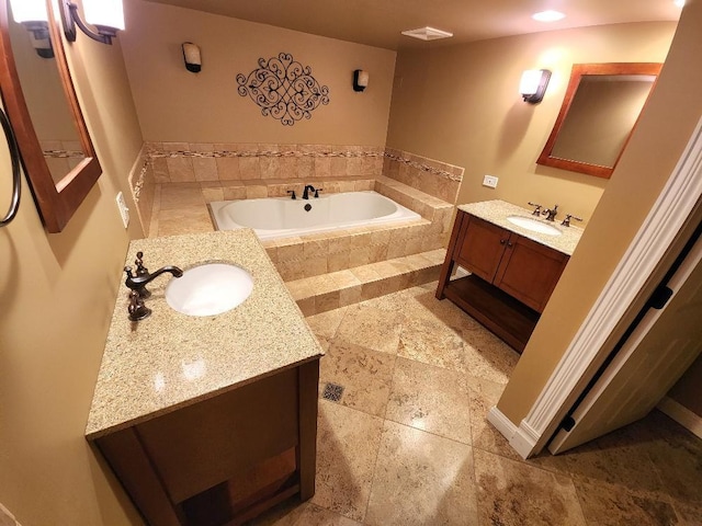 bathroom with vanity and tiled bath