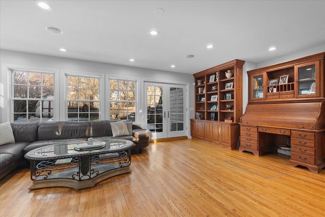 living room featuring light hardwood / wood-style flooring and french doors