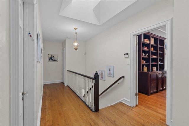 hallway with light hardwood / wood-style flooring