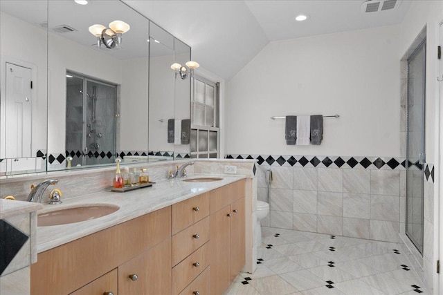 bathroom featuring vanity, an enclosed shower, tile walls, and vaulted ceiling