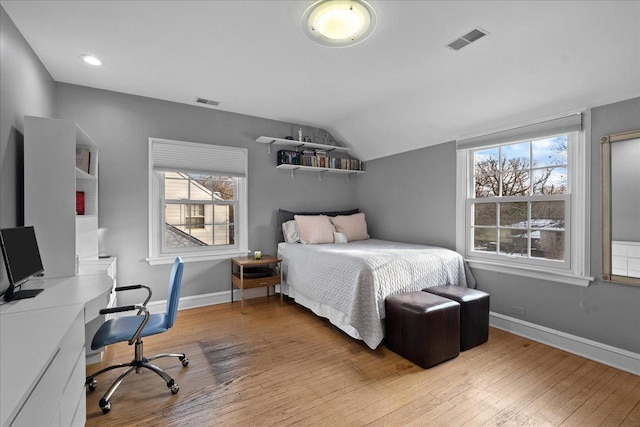 bedroom featuring light hardwood / wood-style flooring and vaulted ceiling