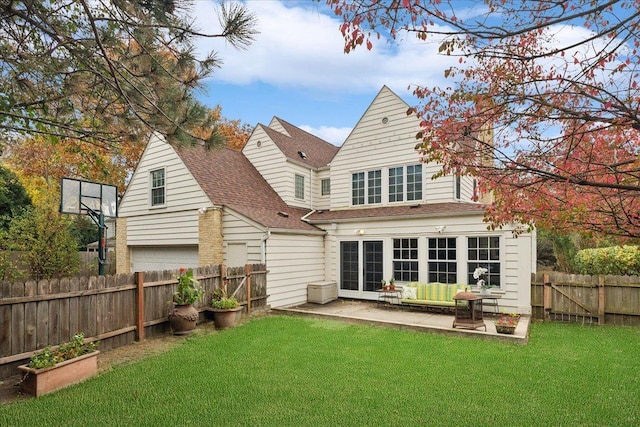 back of house featuring a lawn and a patio