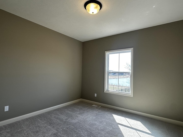 2523 Marble, Normal, IL 61761 - empty room with baseboards, visible vents, dark carpet, and a textured ceiling