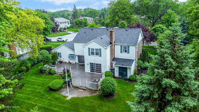 back of property featuring a patio and a lawn