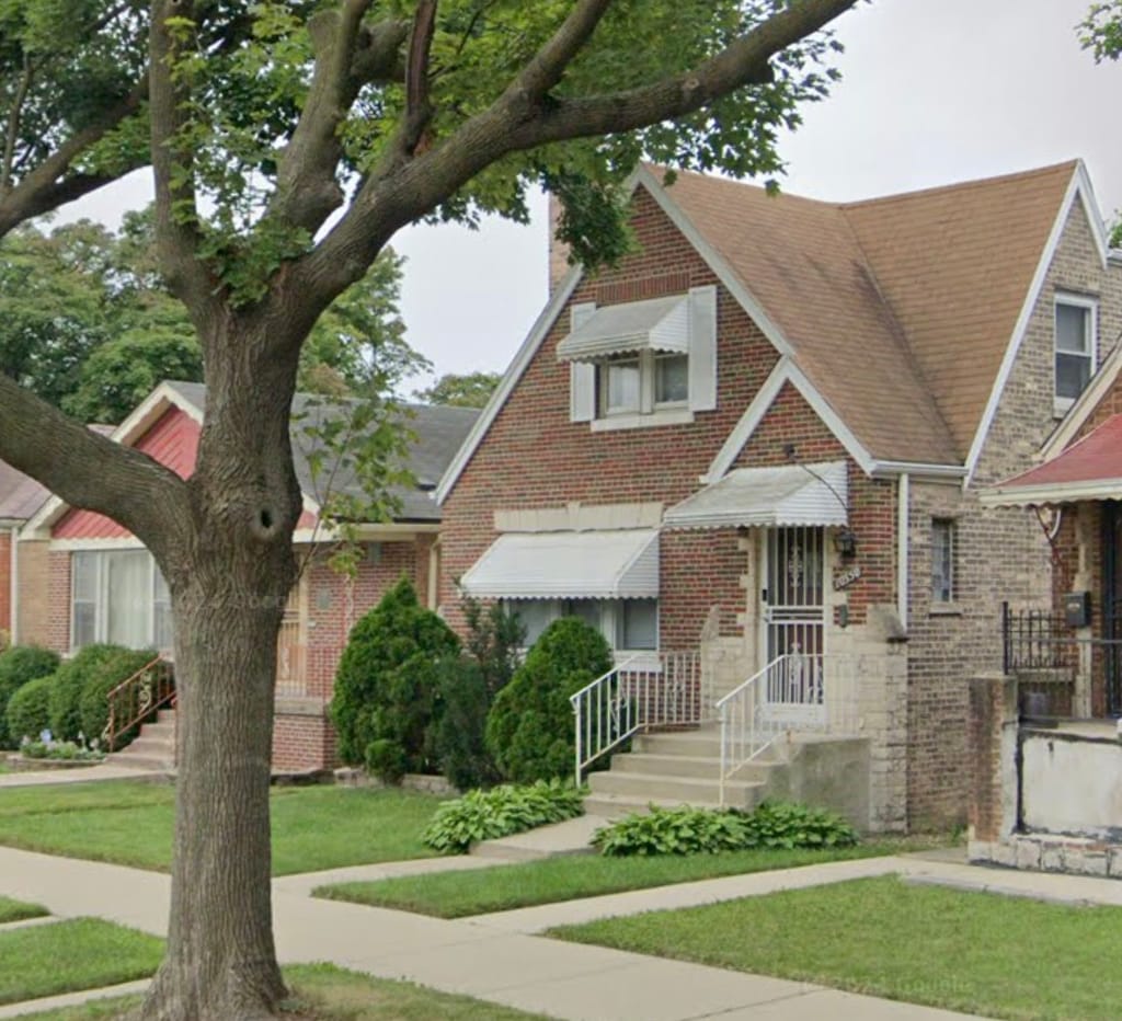 tudor-style house with a front lawn