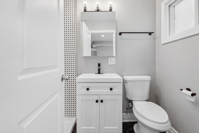 bathroom featuring tile patterned floors, vanity, and toilet