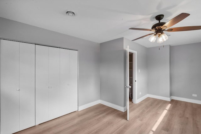 unfurnished bedroom featuring a closet, ceiling fan, and light hardwood / wood-style flooring