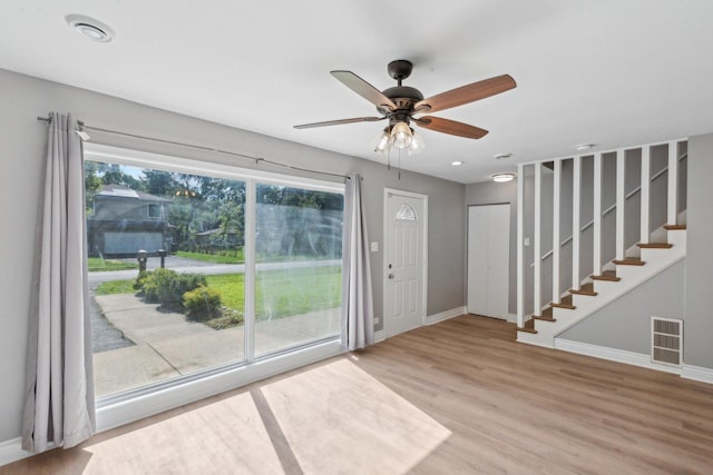 foyer with hardwood / wood-style floors, ceiling fan, and a wealth of natural light