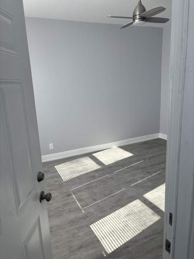 empty room featuring ceiling fan and dark hardwood / wood-style flooring