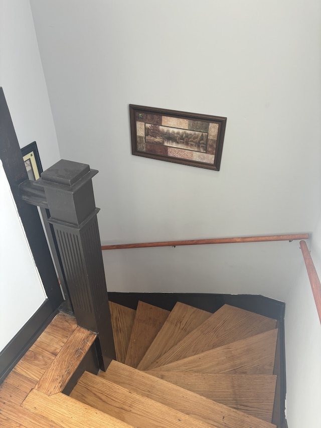 stairs featuring hardwood / wood-style floors