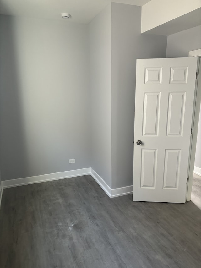 spare room with dark hardwood / wood-style floors