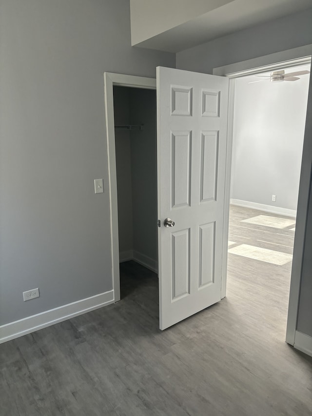 unfurnished bedroom with a closet and wood-type flooring