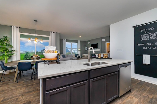 kitchen with dishwasher, an inviting chandelier, sink, dark hardwood / wood-style floors, and light stone countertops