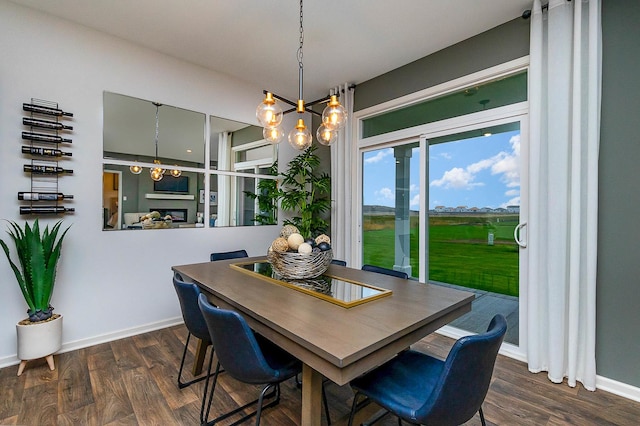 dining space featuring a chandelier and dark hardwood / wood-style floors