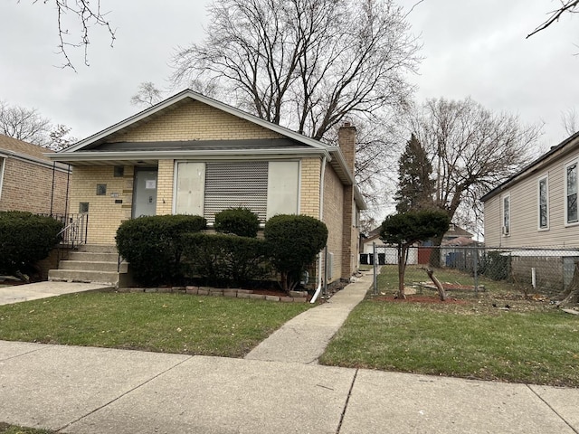 bungalow-style house with a front yard