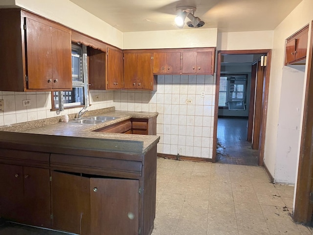 kitchen featuring decorative backsplash, ceiling fan, and sink