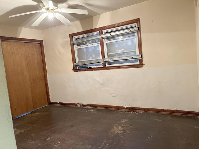 spare room with ceiling fan and dark hardwood / wood-style floors