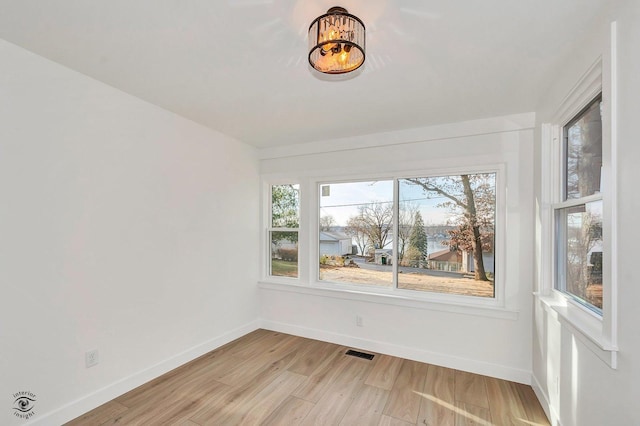 spare room featuring light hardwood / wood-style floors