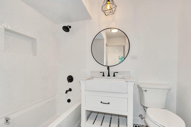 full bathroom featuring tiled shower / bath combo, vanity, and toilet