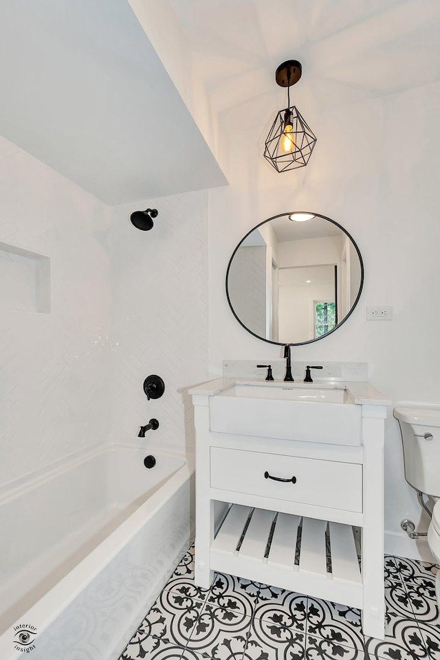 full bathroom with shower / tub combination, tile patterned floors, toilet, and vanity