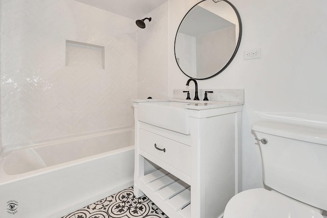 full bathroom with vanity, tiled shower / bath, and toilet