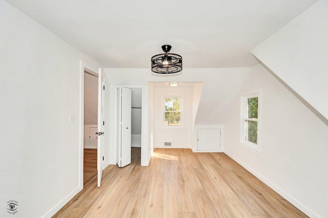 additional living space featuring light hardwood / wood-style flooring