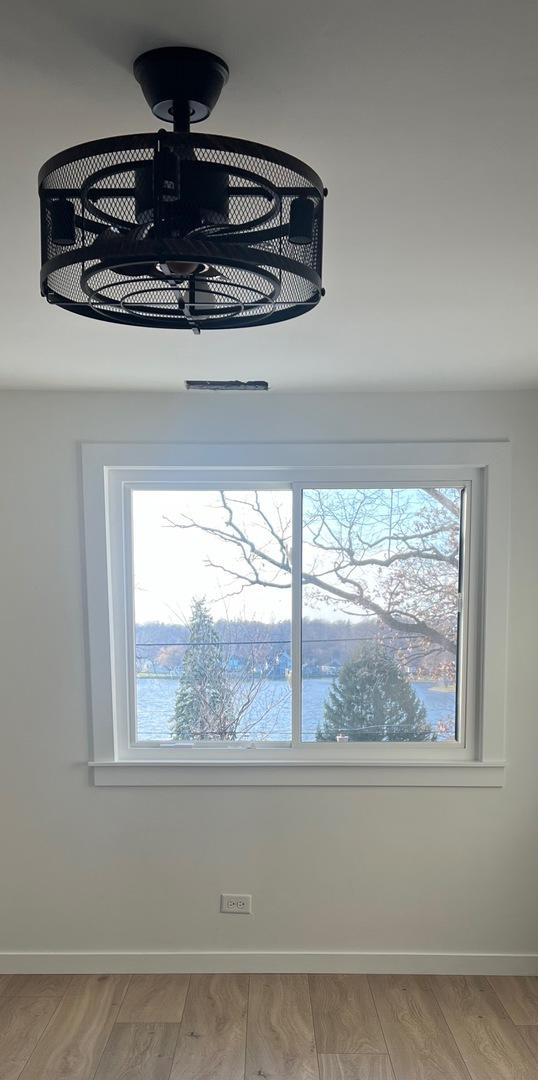 interior details featuring hardwood / wood-style flooring and a water view