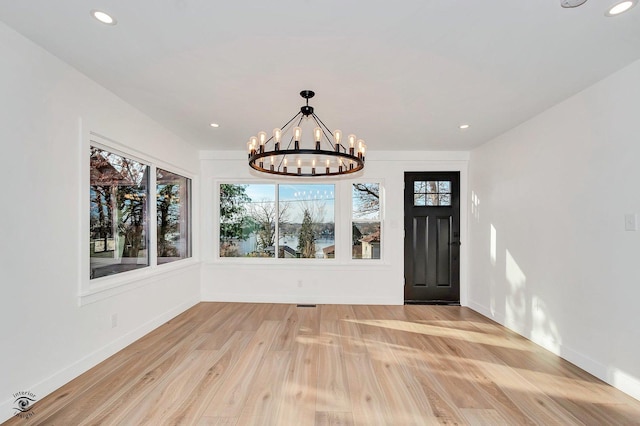 interior space featuring a notable chandelier and light wood-type flooring