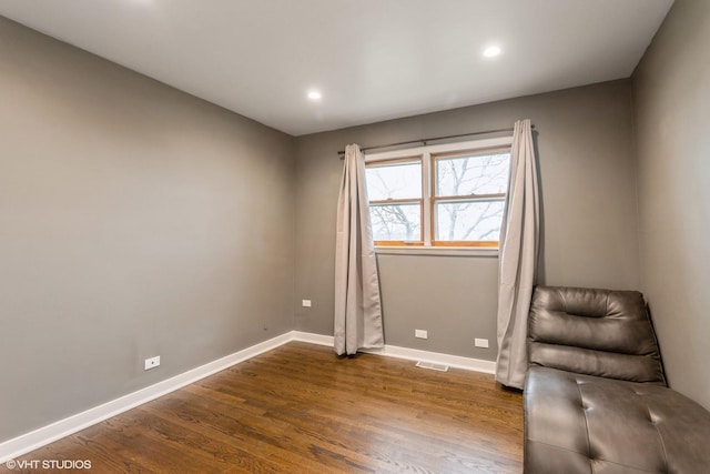 unfurnished room with dark wood-type flooring