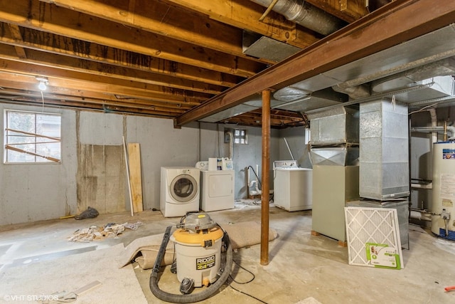 basement with heating unit, water heater, and independent washer and dryer