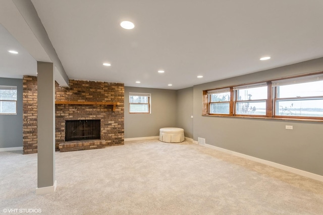 unfurnished living room featuring light colored carpet and plenty of natural light