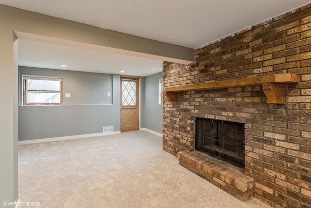 unfurnished living room with light colored carpet and a fireplace