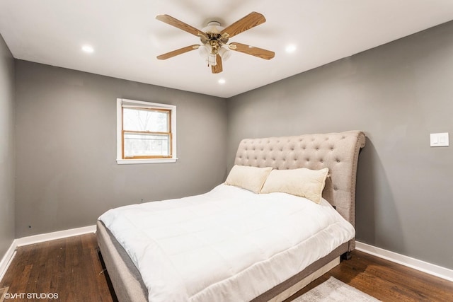 bedroom with dark hardwood / wood-style floors and ceiling fan