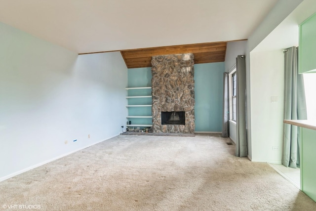 unfurnished living room featuring a fireplace, light colored carpet, and lofted ceiling