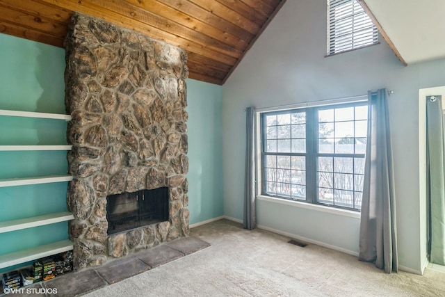 unfurnished living room featuring a stone fireplace, carpet floors, high vaulted ceiling, and wooden ceiling