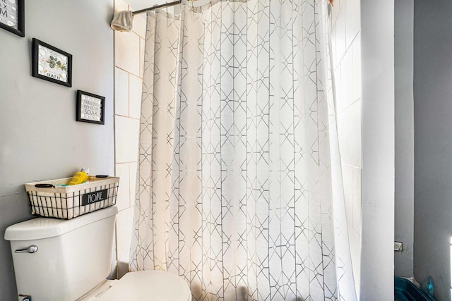 bathroom with shower / tub combo and toilet