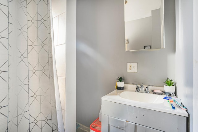 bathroom featuring curtained shower and vanity