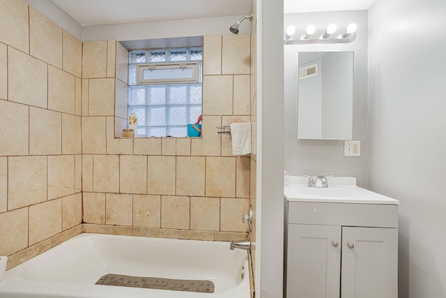 bathroom with washtub / shower combination and vanity