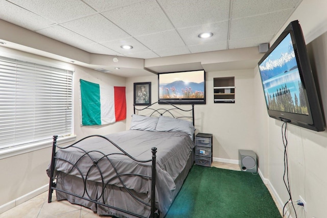 tiled bedroom with a paneled ceiling