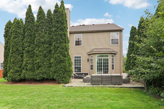 rear view of property featuring outdoor lounge area, a patio, and a lawn