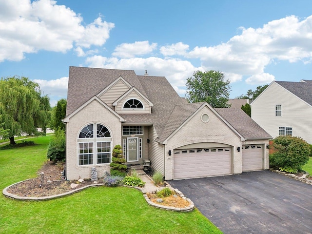 view of front of house with a front yard and a garage