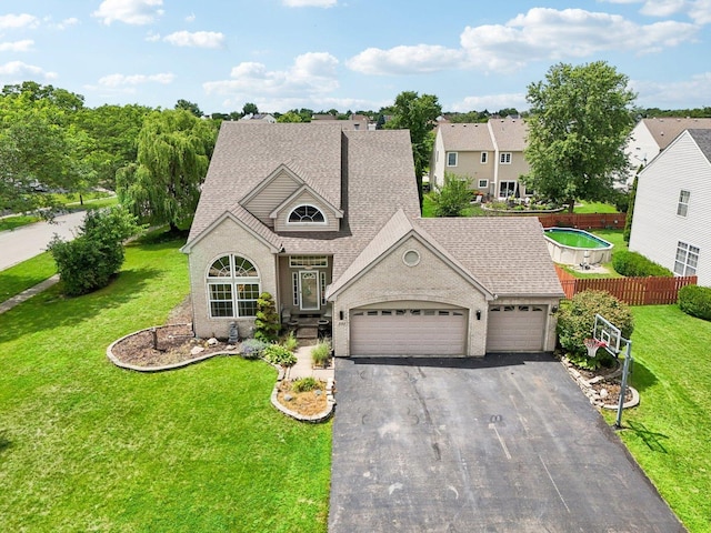 view of front of property featuring a garage and a front lawn