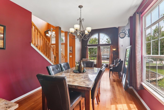 dining space with a chandelier and light hardwood / wood-style flooring