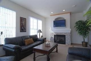 living room with a stone fireplace