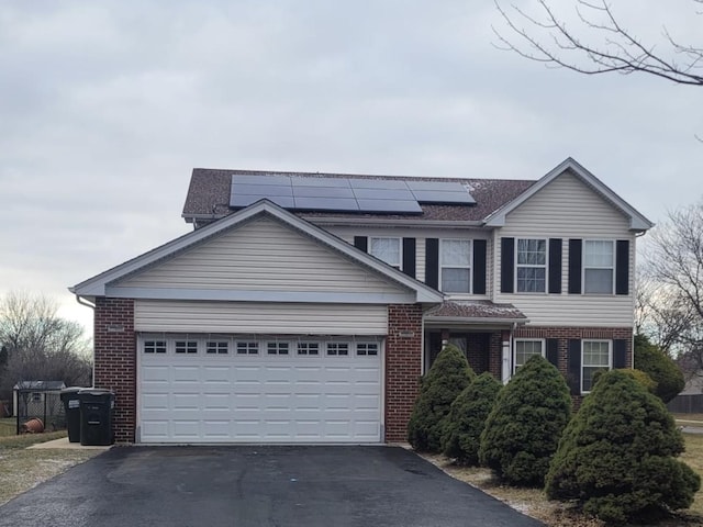 view of front of house with solar panels and a garage