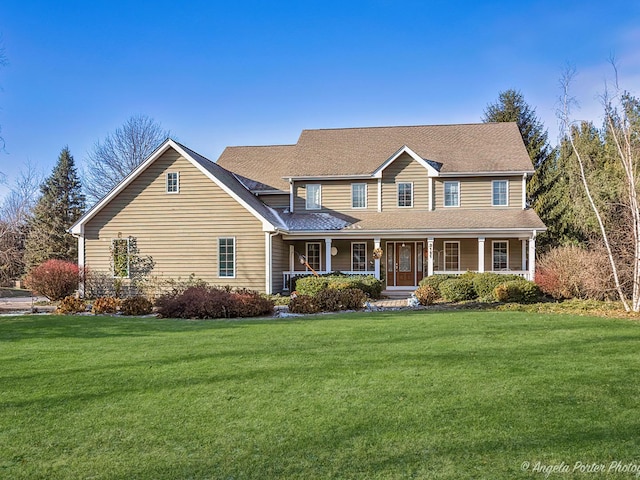 view of front of property with covered porch and a front lawn