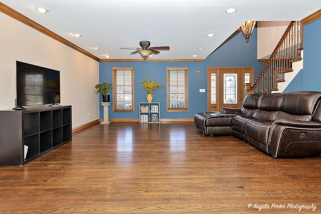 living room with hardwood / wood-style floors, ceiling fan with notable chandelier, and ornamental molding