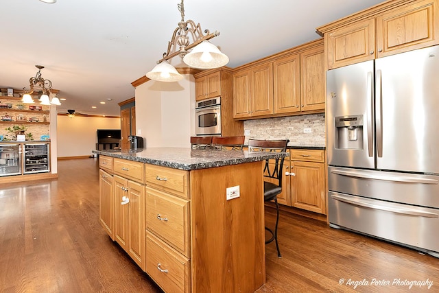 kitchen featuring decorative backsplash, a center island, stainless steel appliances, and dark hardwood / wood-style floors